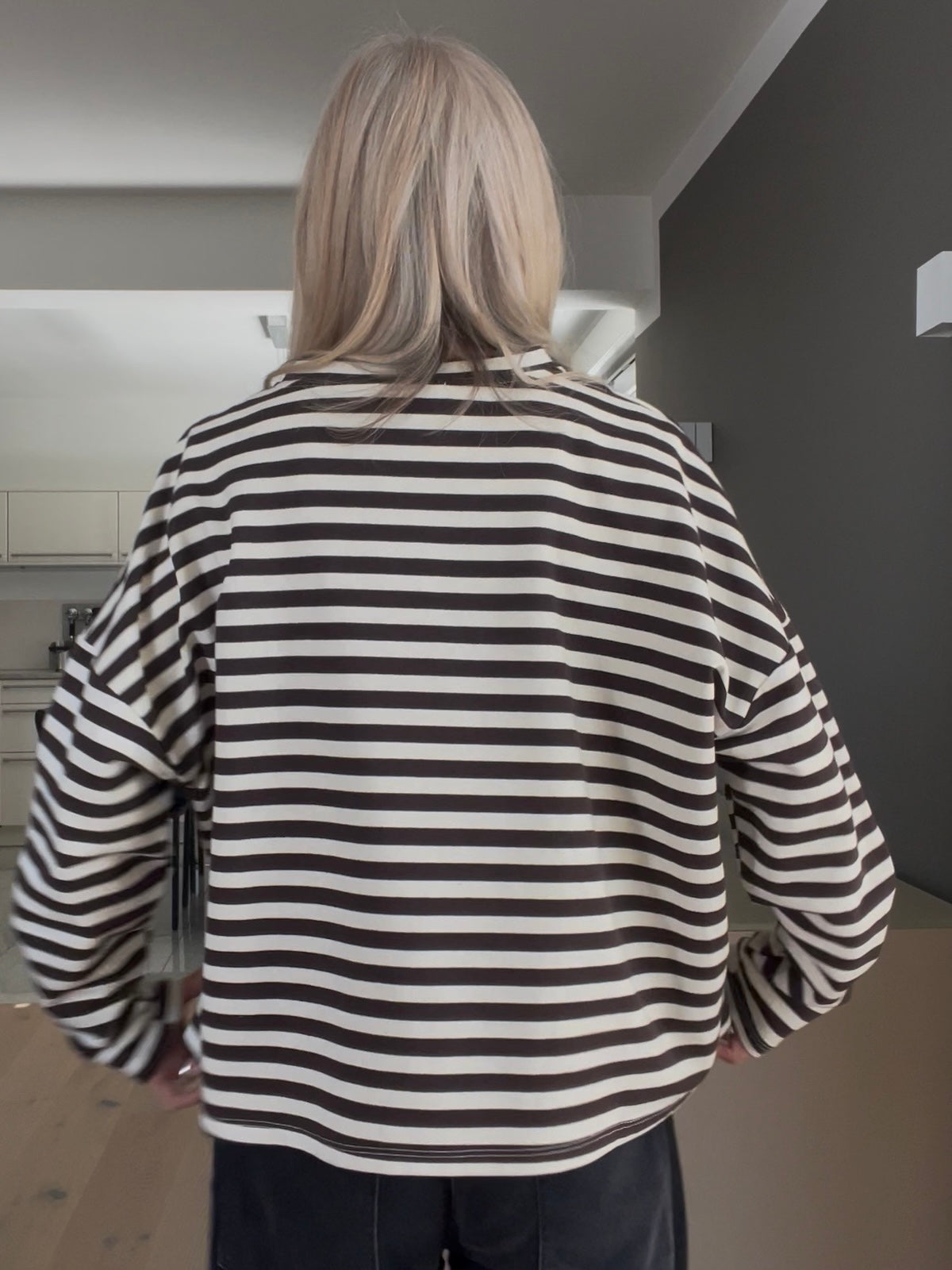 Rückansicht des gestreiften Shirts Velvet in Braun-Creme, die den strukturierten Boxy-Style und die überschnittenen Schultern im sportlich-eleganten Look zeigt.